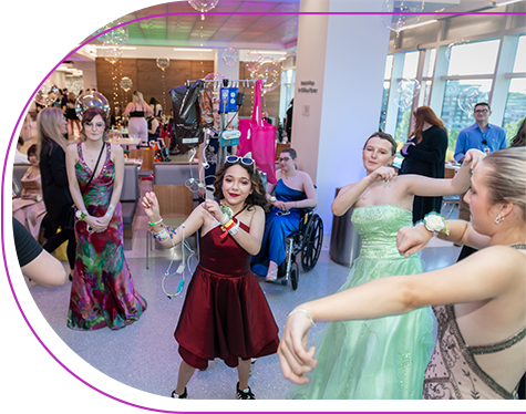 Children's Mercy patients dressed up in prom dresses and dancing at the Patient Prom.