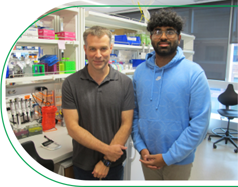 Dr. John Perry standing next to Research Learner Kevin Thomas in the Children’s Mercy Research Institute.