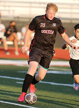 Alexander Armstrong playing soccer.