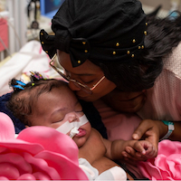 Jazmyne Jones kissing baby while in the NICU.