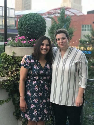 Two members of the Children's Mercy Child Neurology Residency team pose together in a garden.