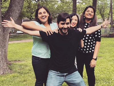 Three members of the Children's Mercy Child Neurology Residency team do a silly pose together outdoors.