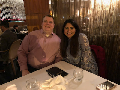 Two members the Children's Mercy Child Neurology Residency team pose together at a restaurant table.