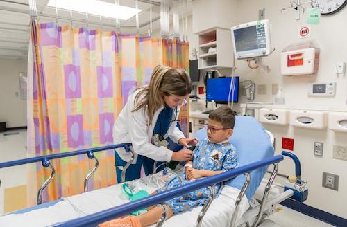 female nurse checking patient blood pressure after surgery 