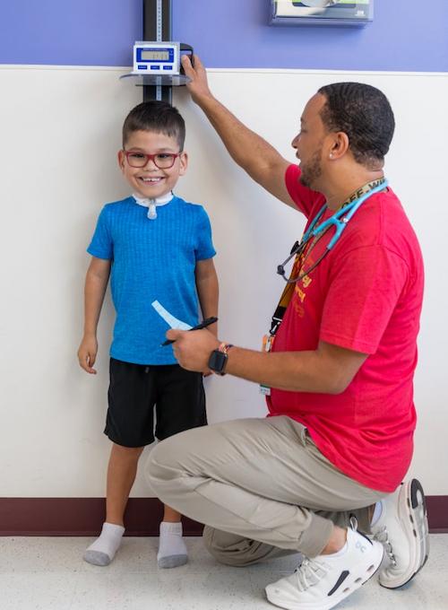 Nurse conducting height of patient before surgery.