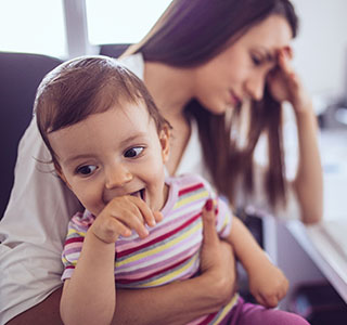 Frustrated mom holding child