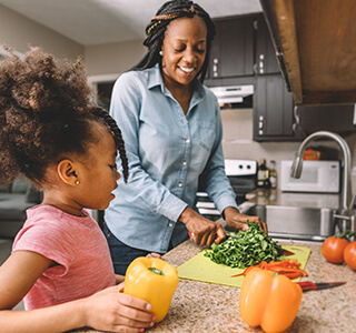 mom and daughter chop vegetables celiac disease