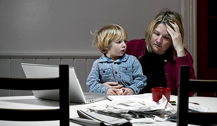 Mom at table frustrated looking at papers