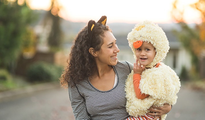 Mom holding child in chicken costume