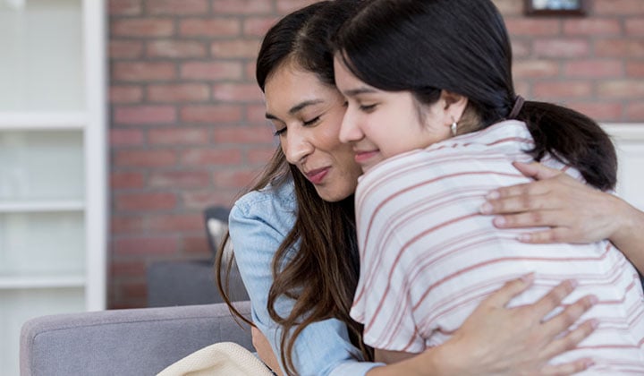 mom hugging daughter