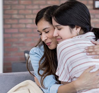 mom and daughter hugging