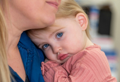 A close-up view of 2 year old patient, June. She is a girl with blonde hair, blue eyes and light skin.