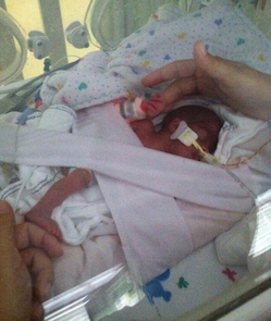 Baby Kaydee in a crib in the NICU