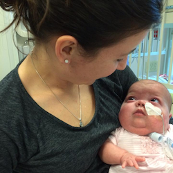 Kaydee's mom holds young Kaydee in her arms