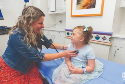 Mayia shares a smile during her exam with neuro-oncology nurse practitioner Diana Healy.